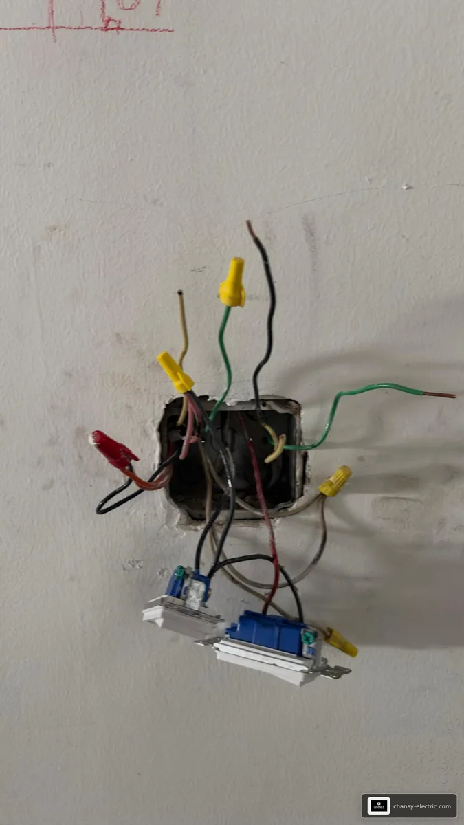 Open electrical box with exposed wires during troubleshooting